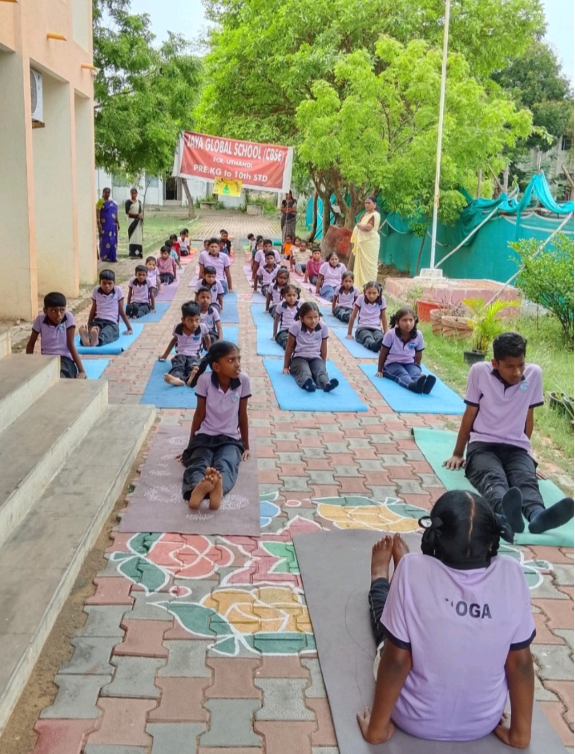 Students practicing yoga outdoors